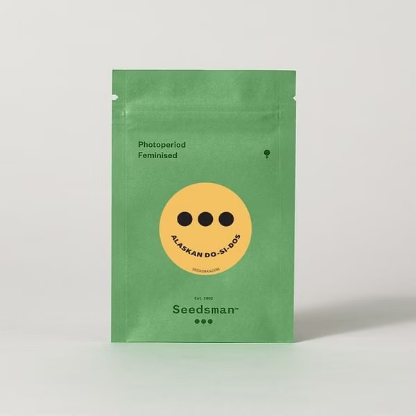 Photo of a Seedsman seed package showcasing a light green colored pouch type package with a yellow smiley face type logo in the middle.