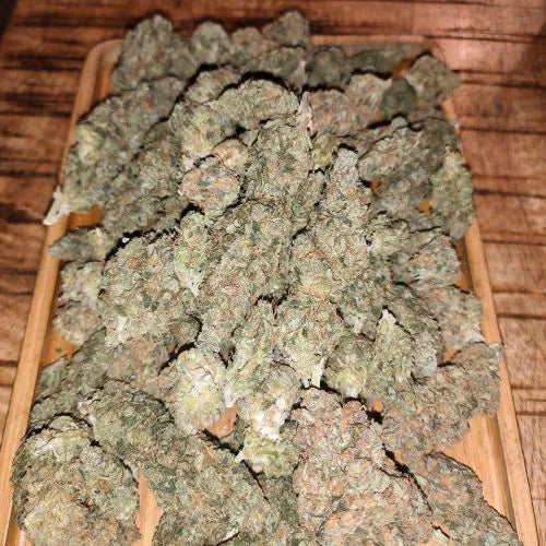 Close-up of cannabis buds on a wooden tray