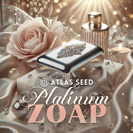 A luxury-style product graphic for Atlas Seed Platinum Zoap soap. A rectangular silver soap bar with an ornate silver emblem sits on a white marble slab, surrounded by a pale blush rose, metallic beads, and draped satin.